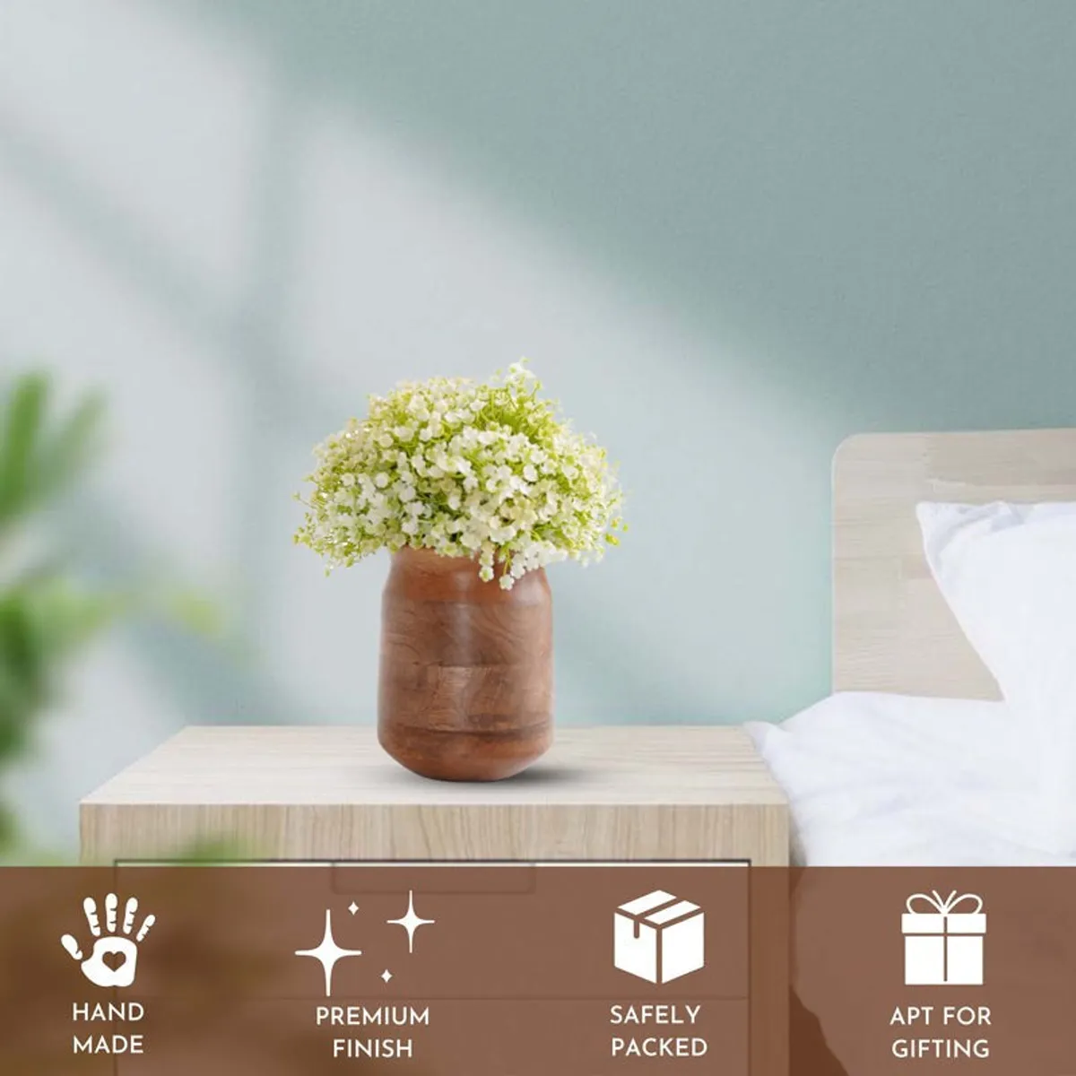 Dark brown wooden vase with white flowers styled on a bedside table