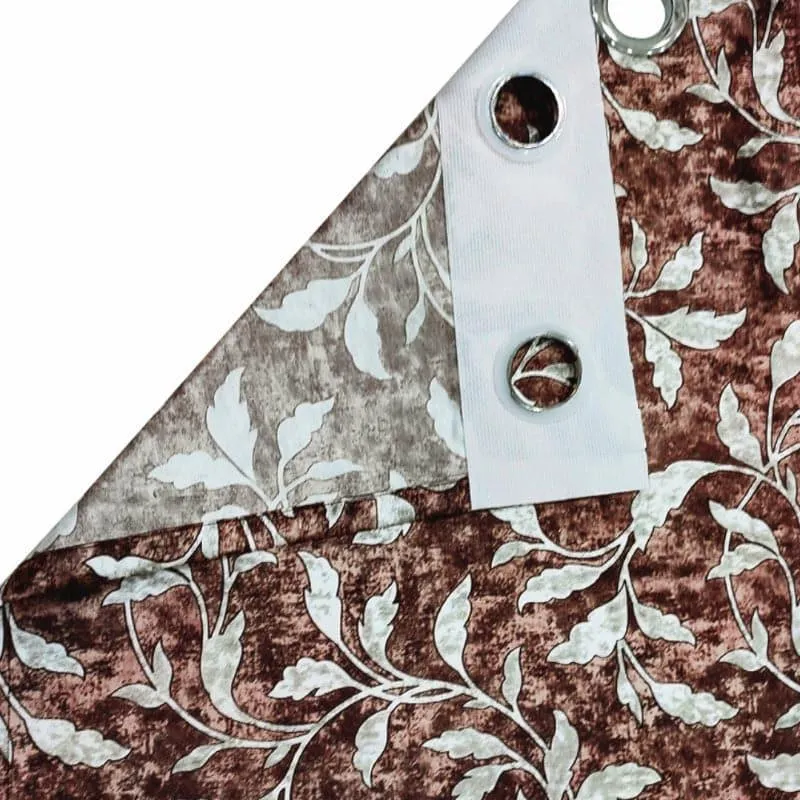 Close-up showing the printed brown leaf pattern and silver eyelet detail.