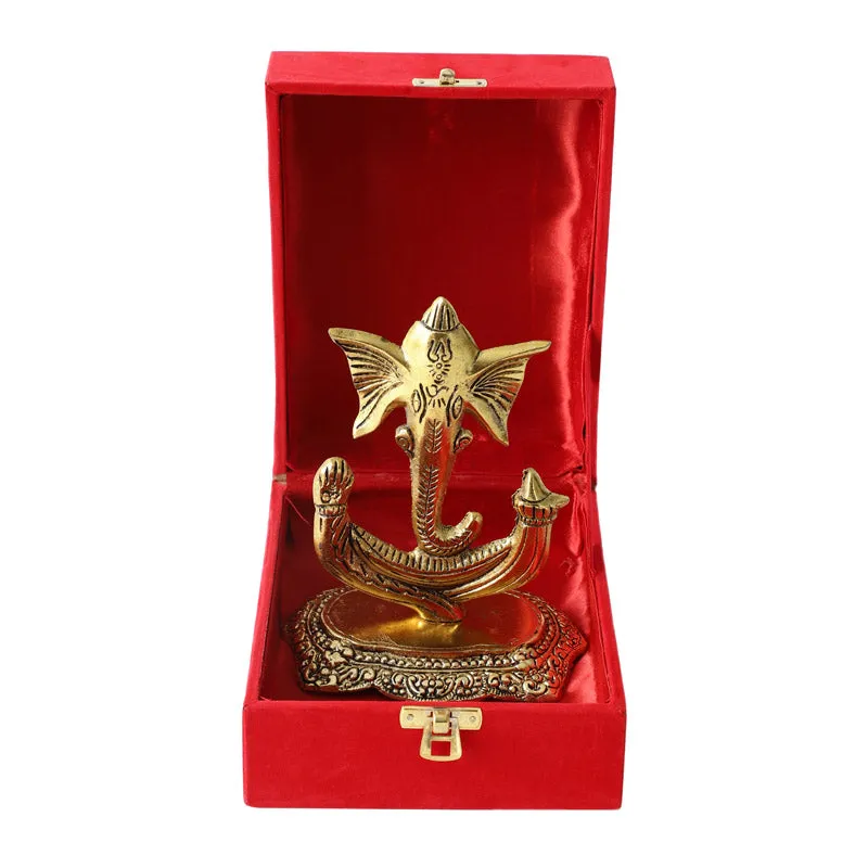 Gold-toned Vinakaya idol placed inside a red gift box