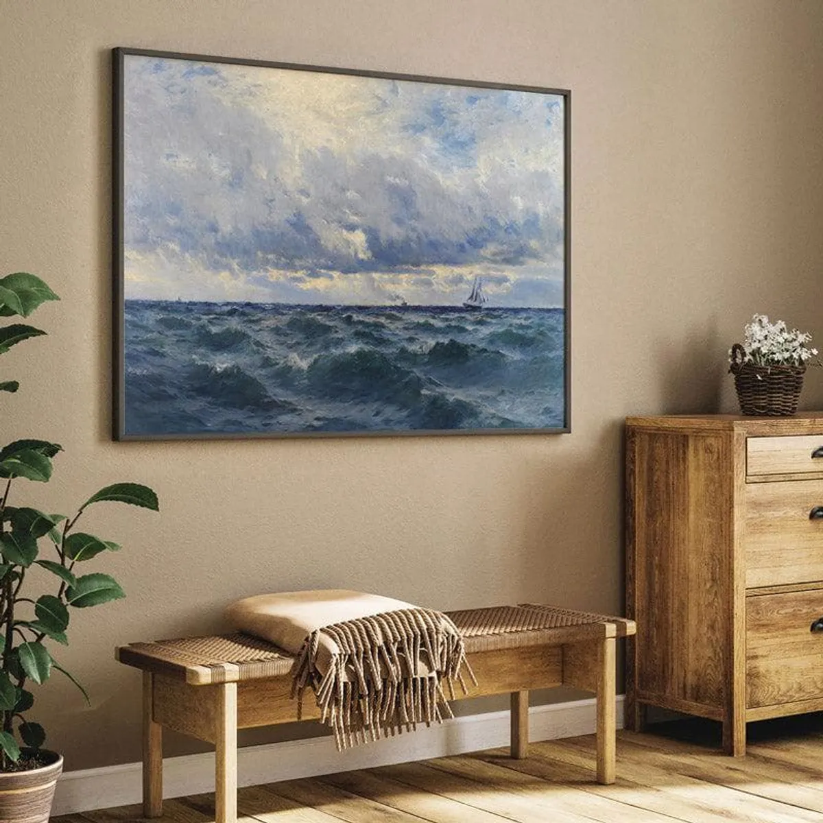 Close view of framed seascape wall art above a wooden bench and cabinet.