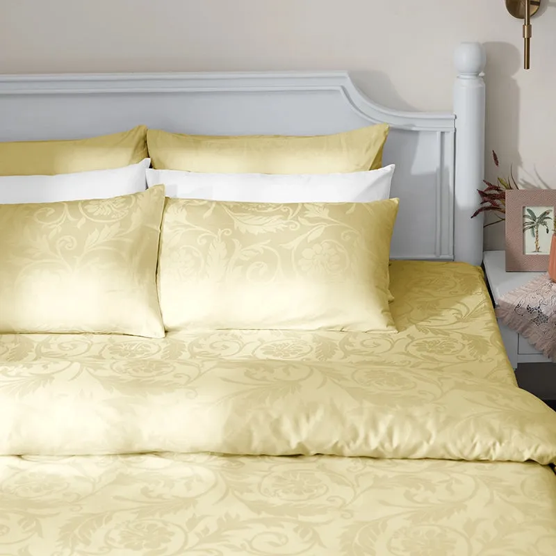 Ivory floral jacquard duvet cover styled on a bed with matching pillows