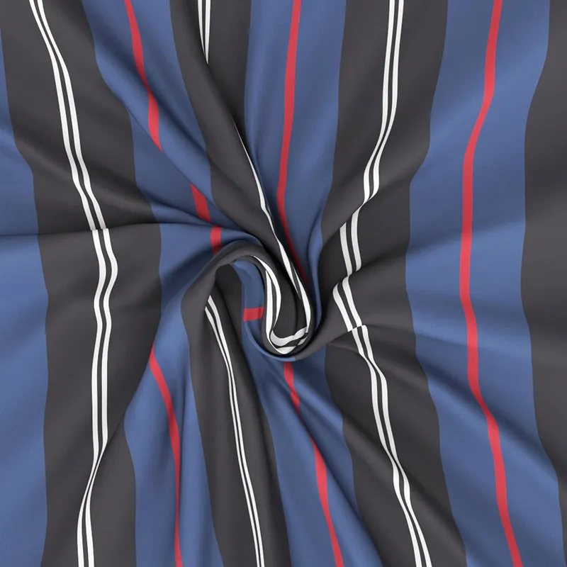Textured close-up of the striped blue, charcoal, white and red bedsheet