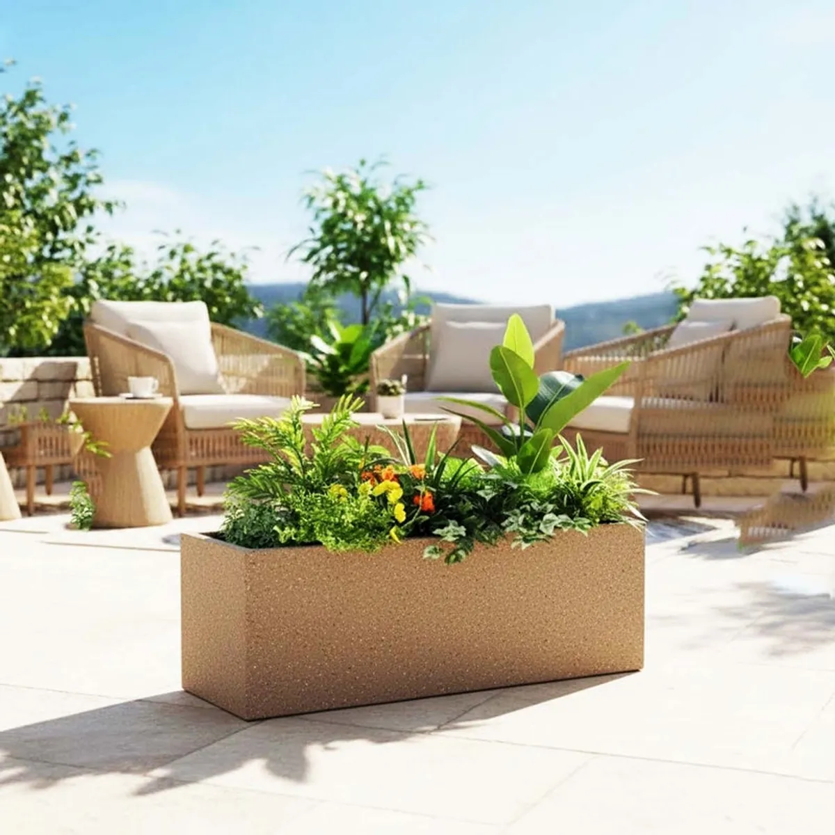 Brown rectangular planter filled with colourful plants on an outdoor patio.