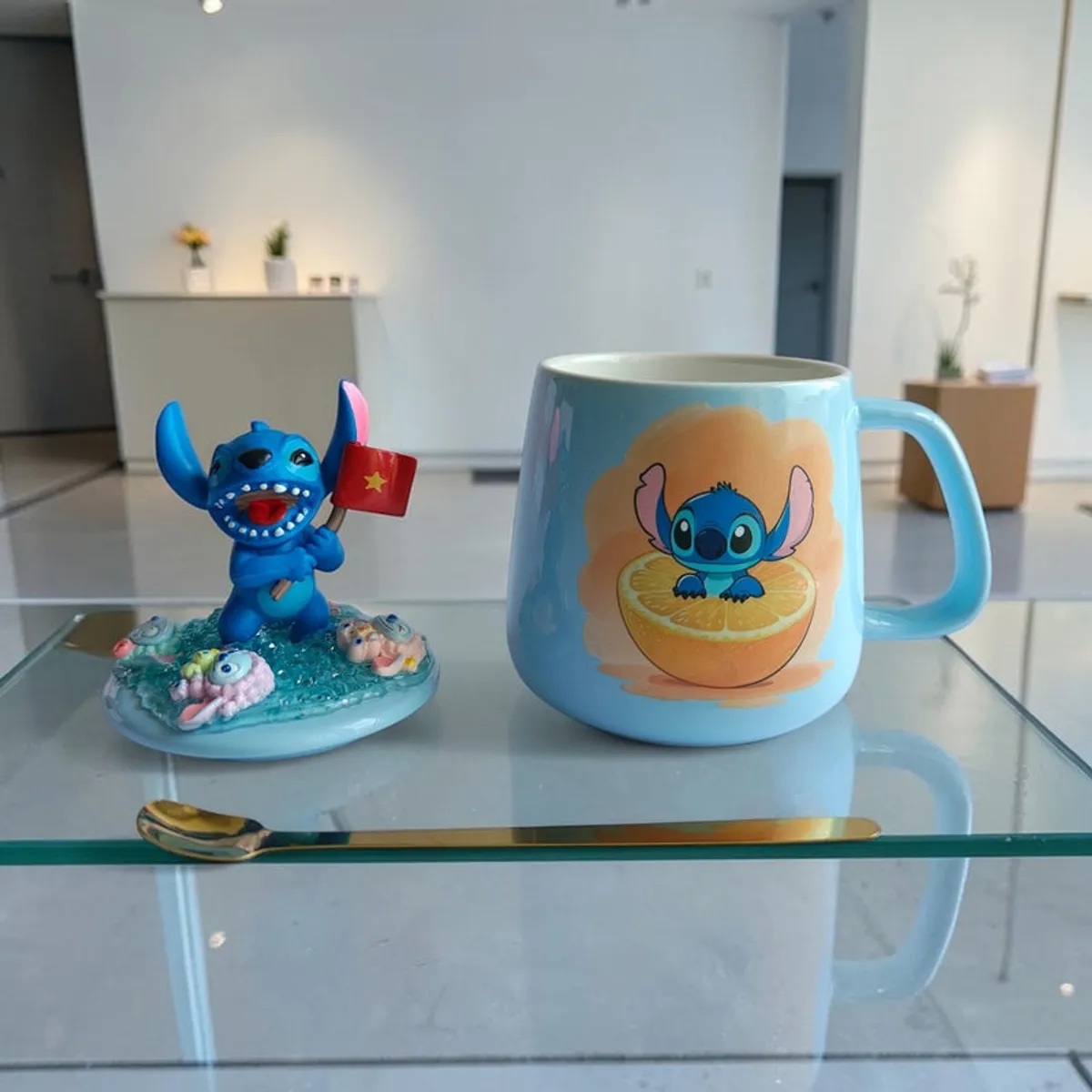 Front view of blue Stitch mug with citrus print and matching decorative topper