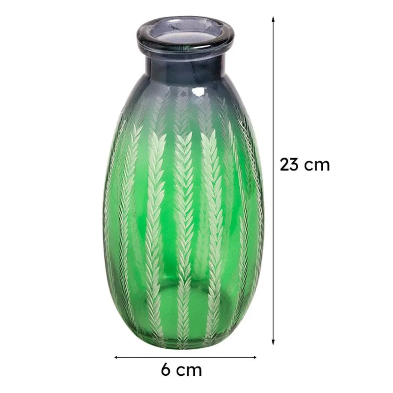 Green glass bottle vase with etched leaf pattern on a plain background