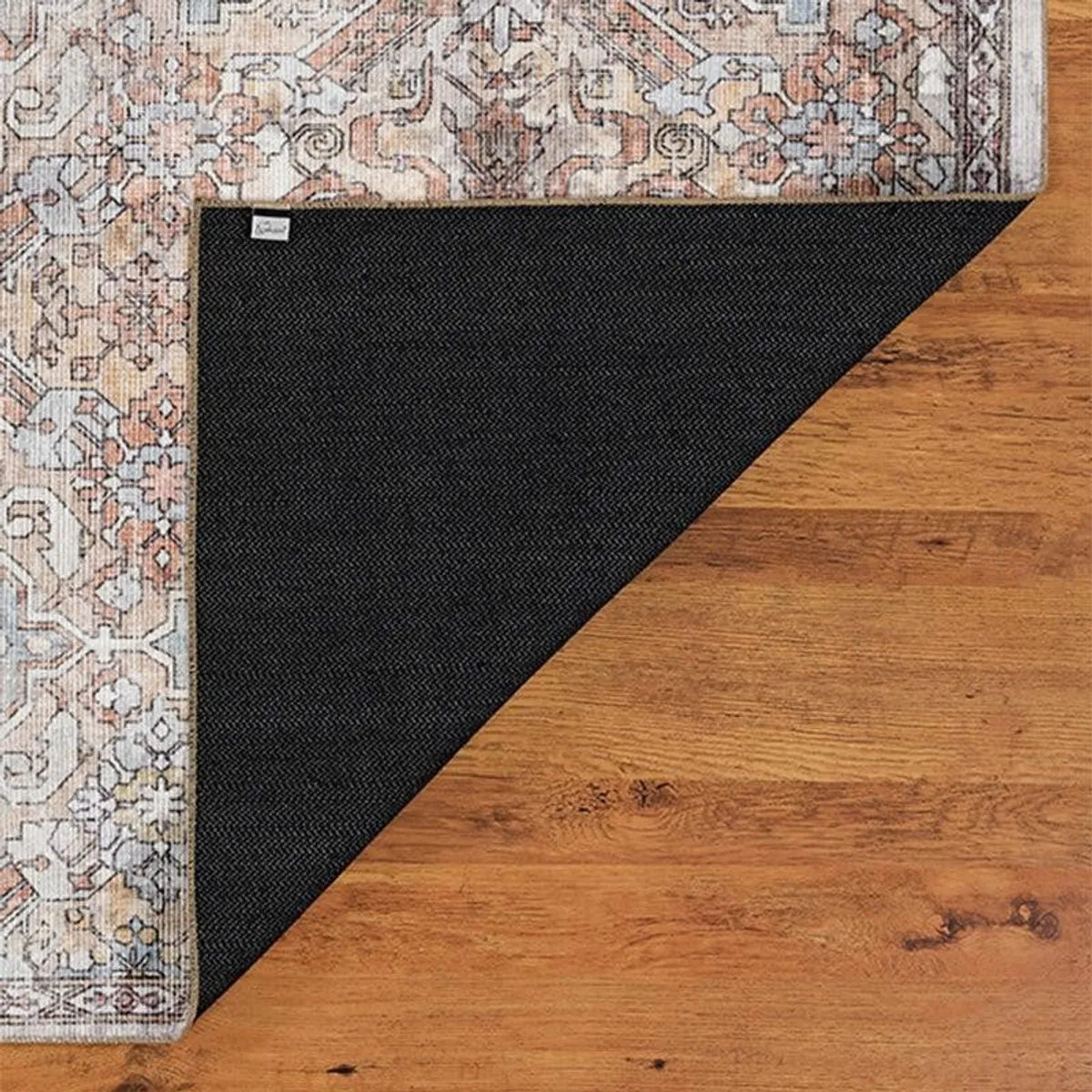 Underside corner of the carpet showing black backing