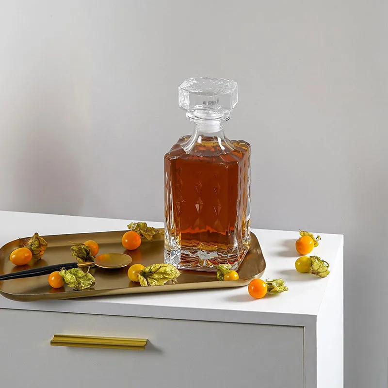Front view of a clear crystal glass decanter with geometric cut pattern