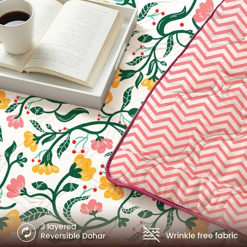 Close-up of reversible bedding showing floral print and pink geometric pattern