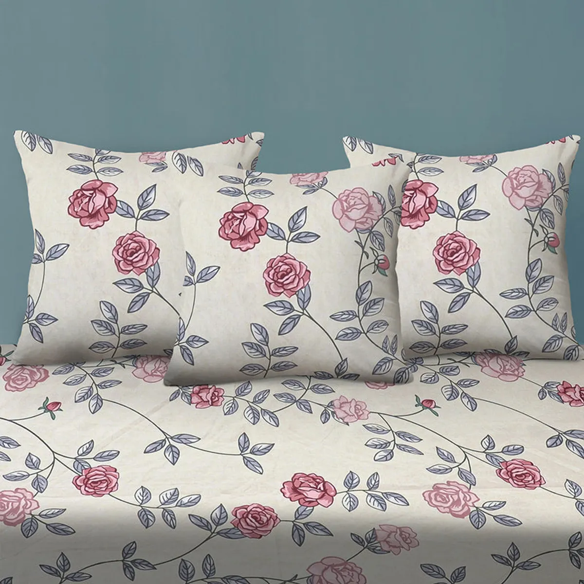 Three matching cushion covers with pink rose print on white fabric