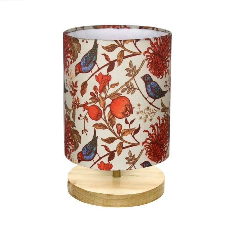 Side view showing the cylindrical patterned fabric shade and wooden lamp base