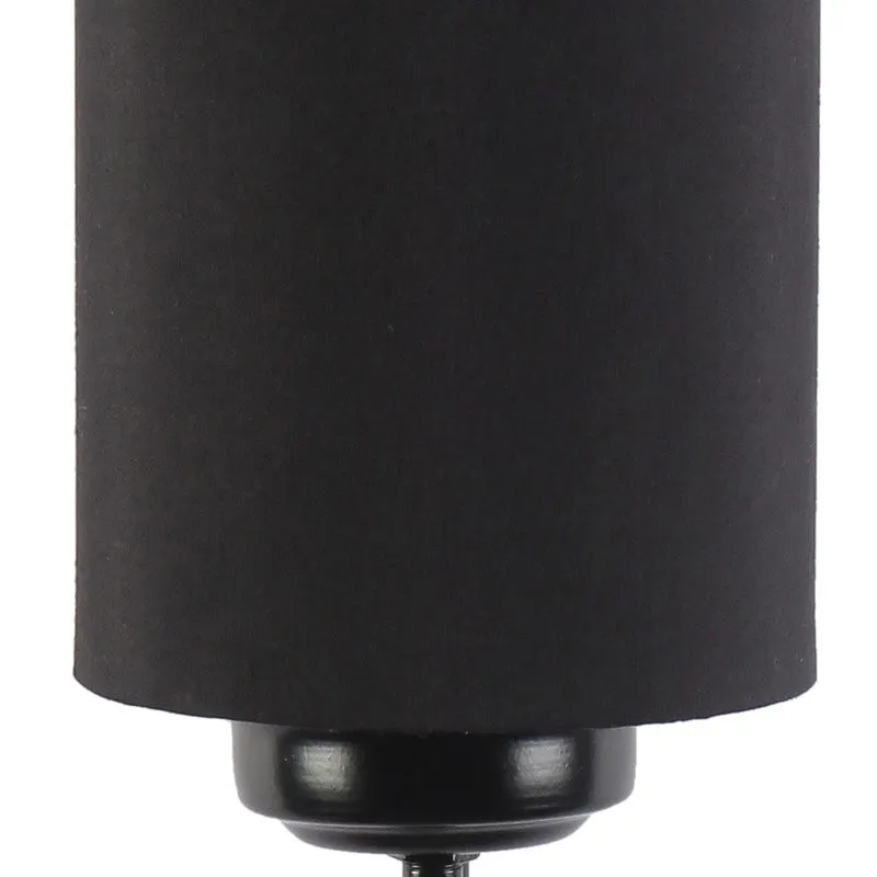 Close-up of the black lamp base and lower edge of the cotton shade