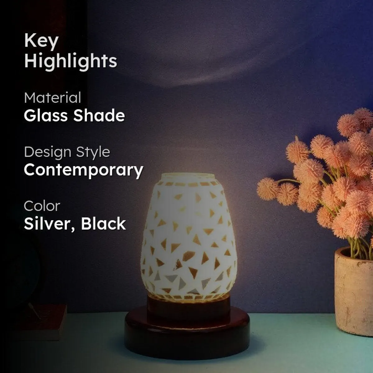 Lit silver and black mosaic table lamp in a styled room setting