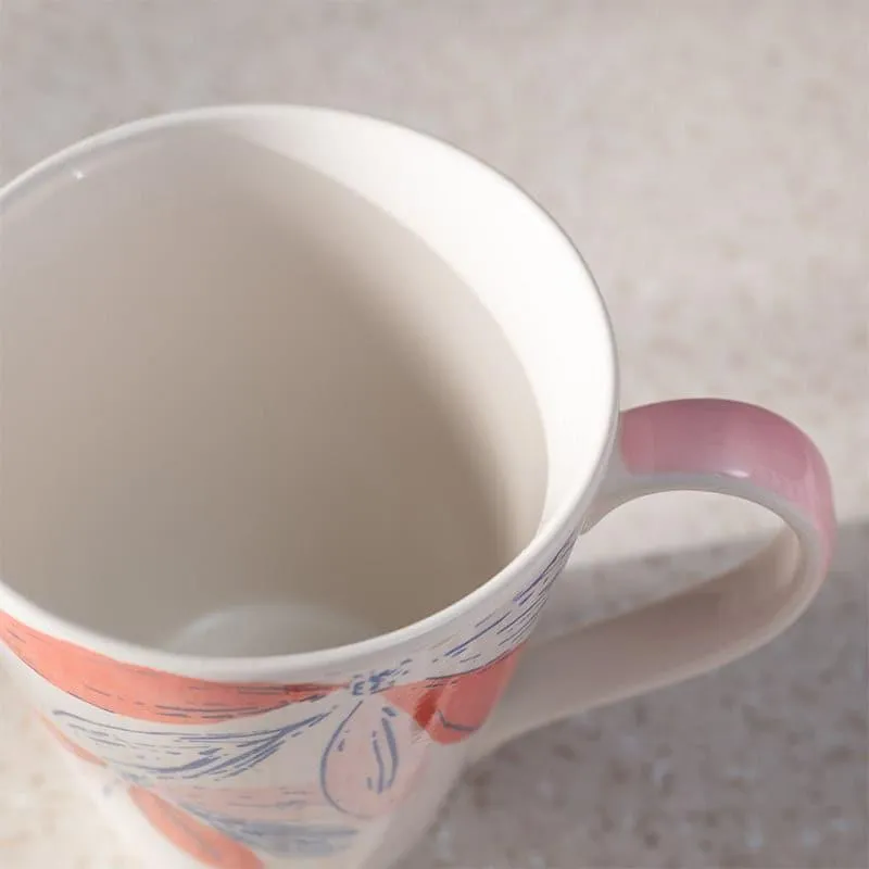 Top view showing the white interior and pink-accented handle of the floral mug