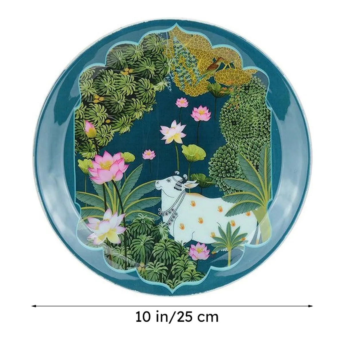 Close-up of a blue round wall plate with a white cow, lotus flowers and foliage
