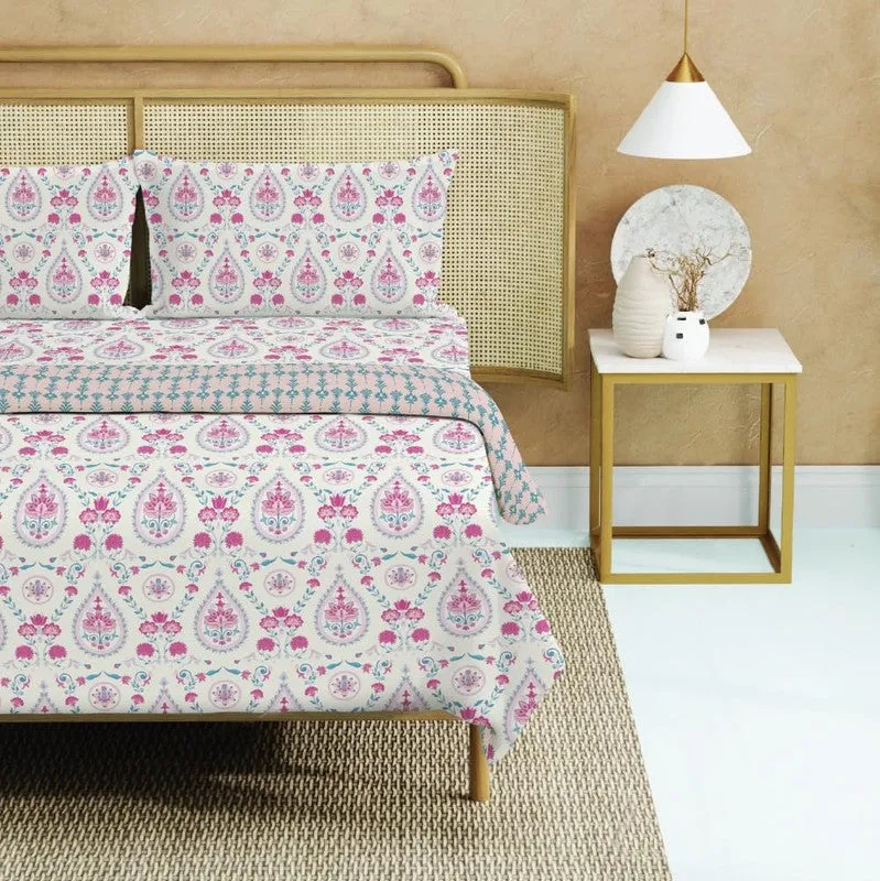 Close view of multicolour bedding set with pink paisley-style ethnic pattern
