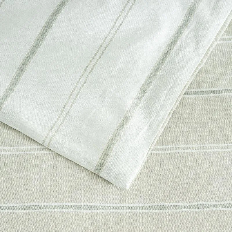 Close-up of a beige pillow cover and duvet cover with fine stripes.
