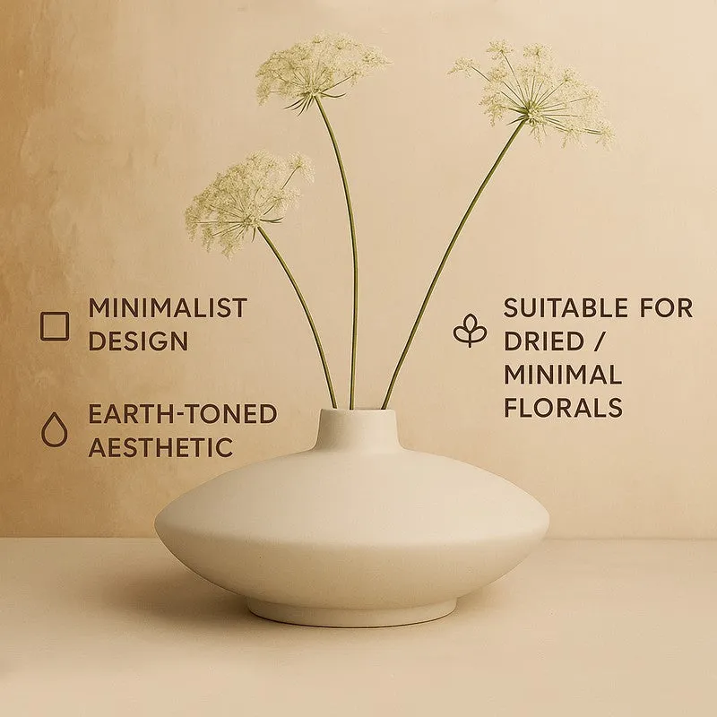 Ivory low bowl vase with floral stems and minimalist design text