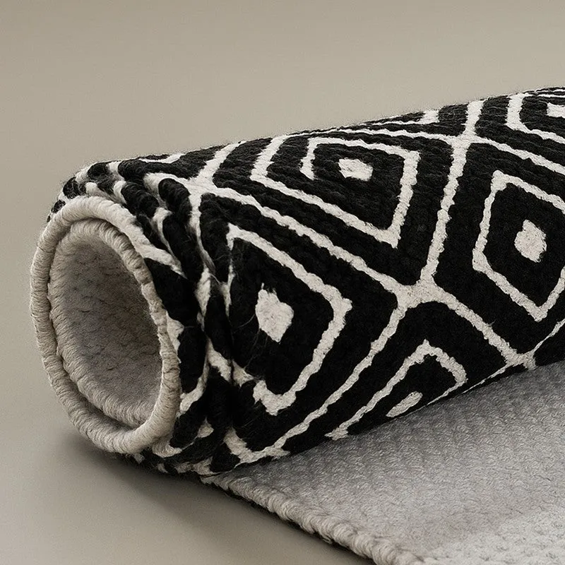 Rolled black and off-white runner rug showing underside