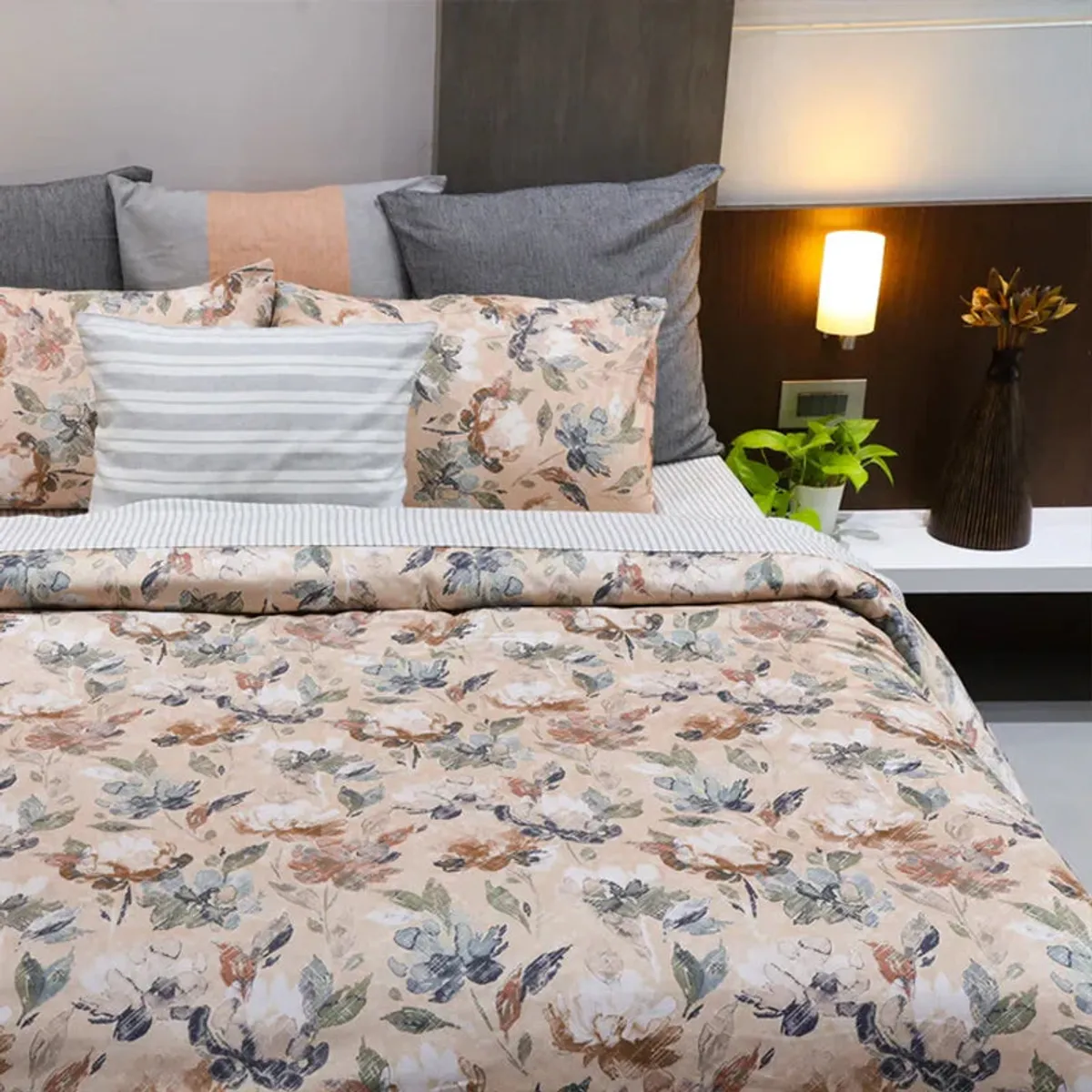 Beige floral cotton duvet cover styled on a bed with matching floral pillows