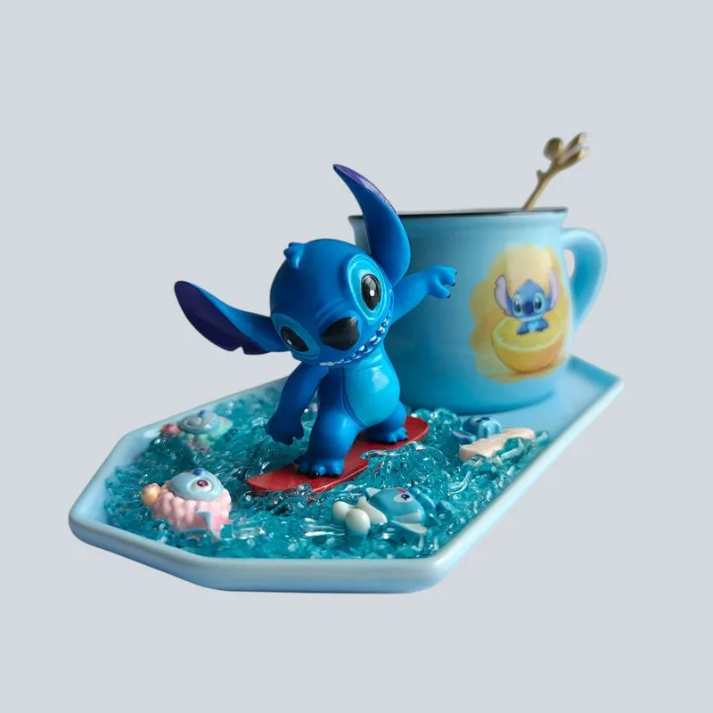 Close view of a blue character figurine beside a matching ceramic mug on a decorative tray