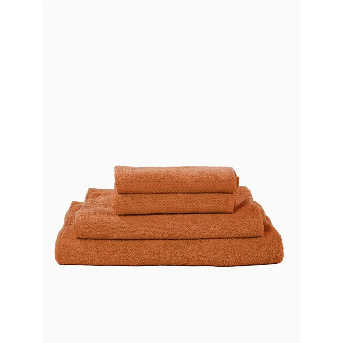Side view of folded orange towels stacked by size
