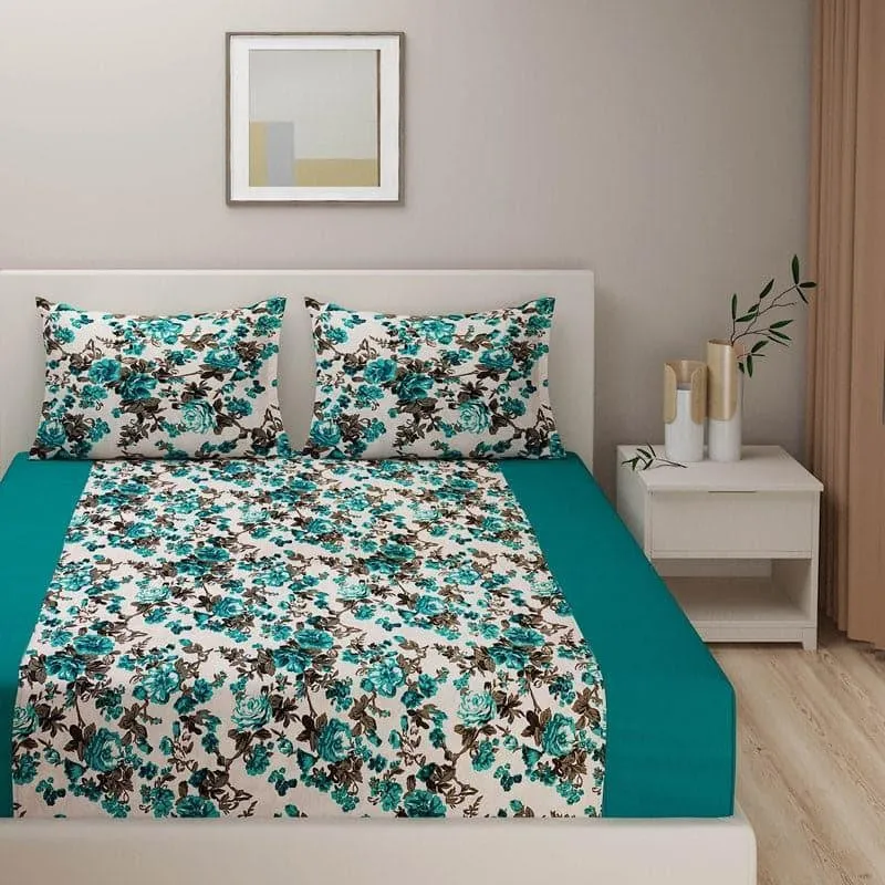 Front view of cream bedsheet with teal floral print and matching pillow covers