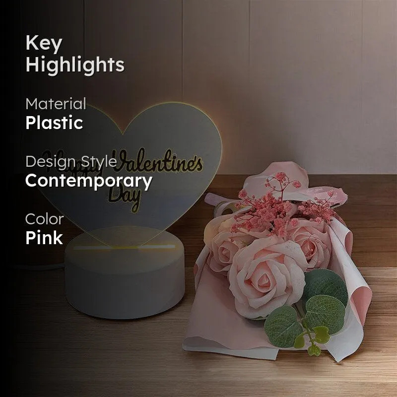 Heart-shaped Valentine's showpiece and pink rose arrangement shown in a styled setting.