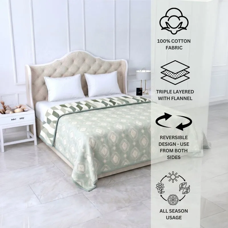 Olive green reversible dohar styled on a bed with printed details visible