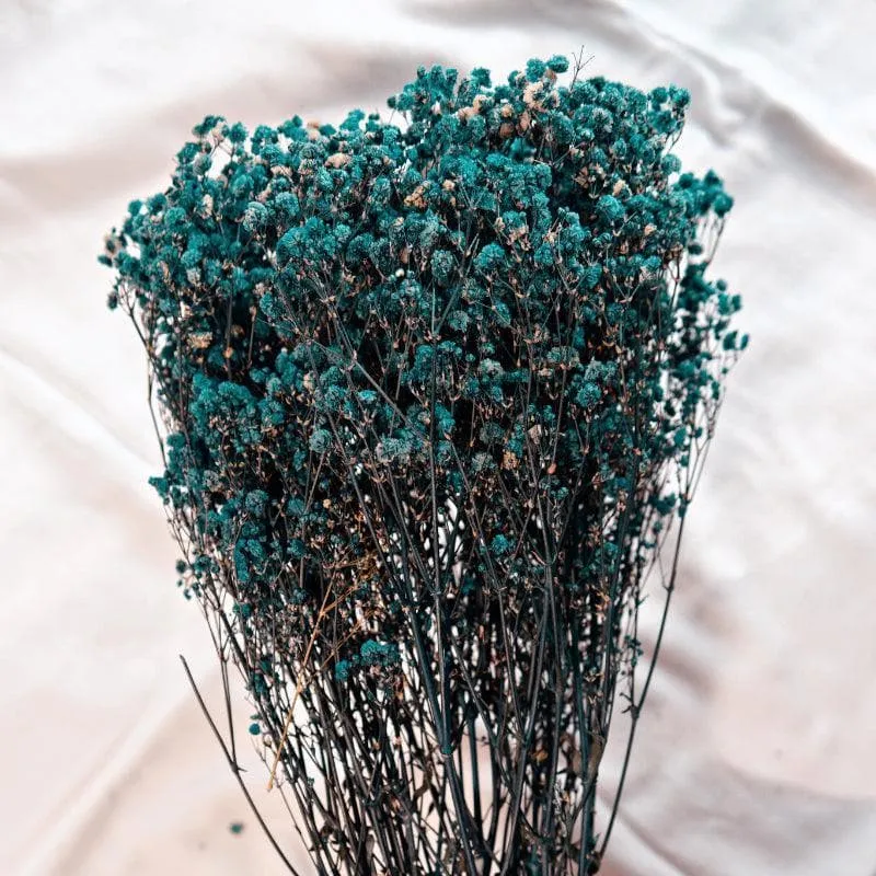 Detailed view of blue dried baby breath blooms arranged as a dense bouquet.