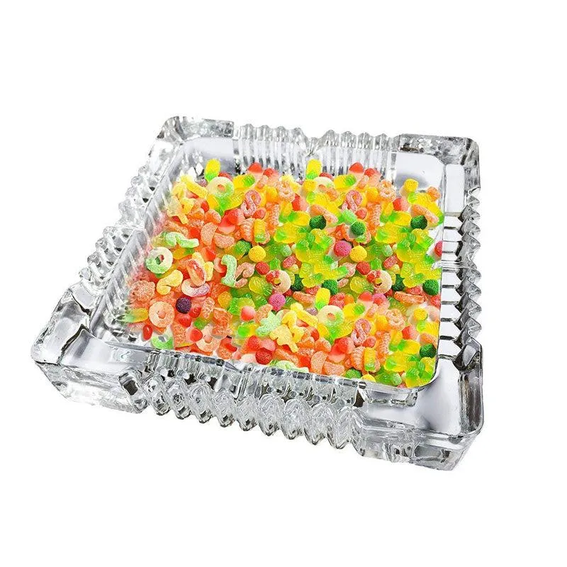 Transparent glass ashtray filled with colourful sweets