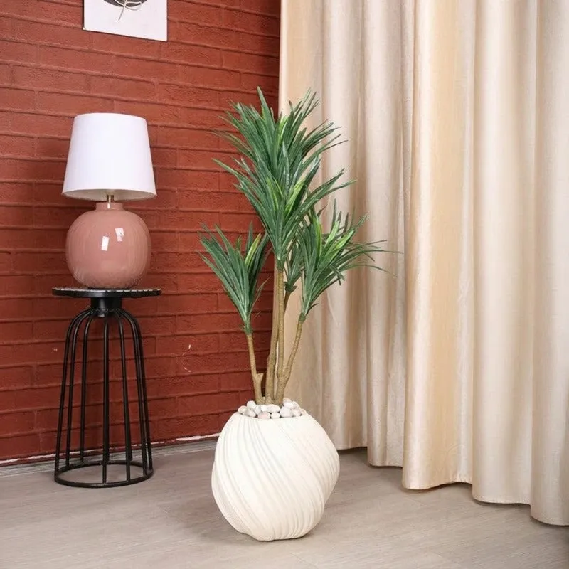 Close view of a white spiral-ribbed planter holding a green plant