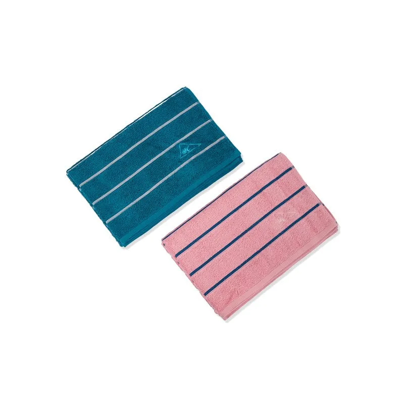Blue and pink striped bath towels laid flat on a white background