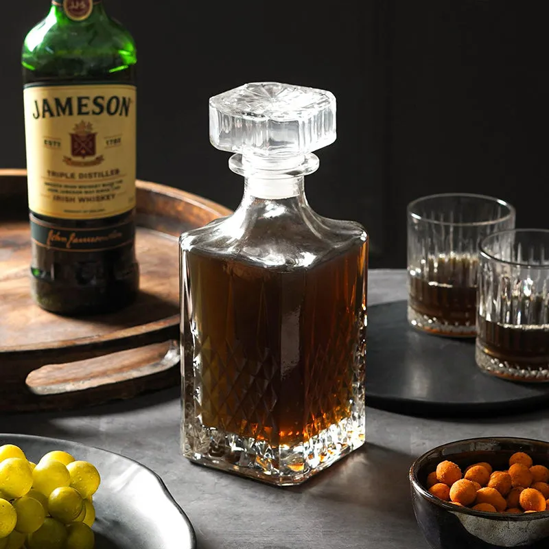 Transparent prism-pattern decanter with stopper styled beside glasses