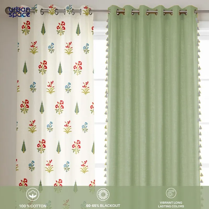 Close view of green and floral curtain panels on an eyelet rod