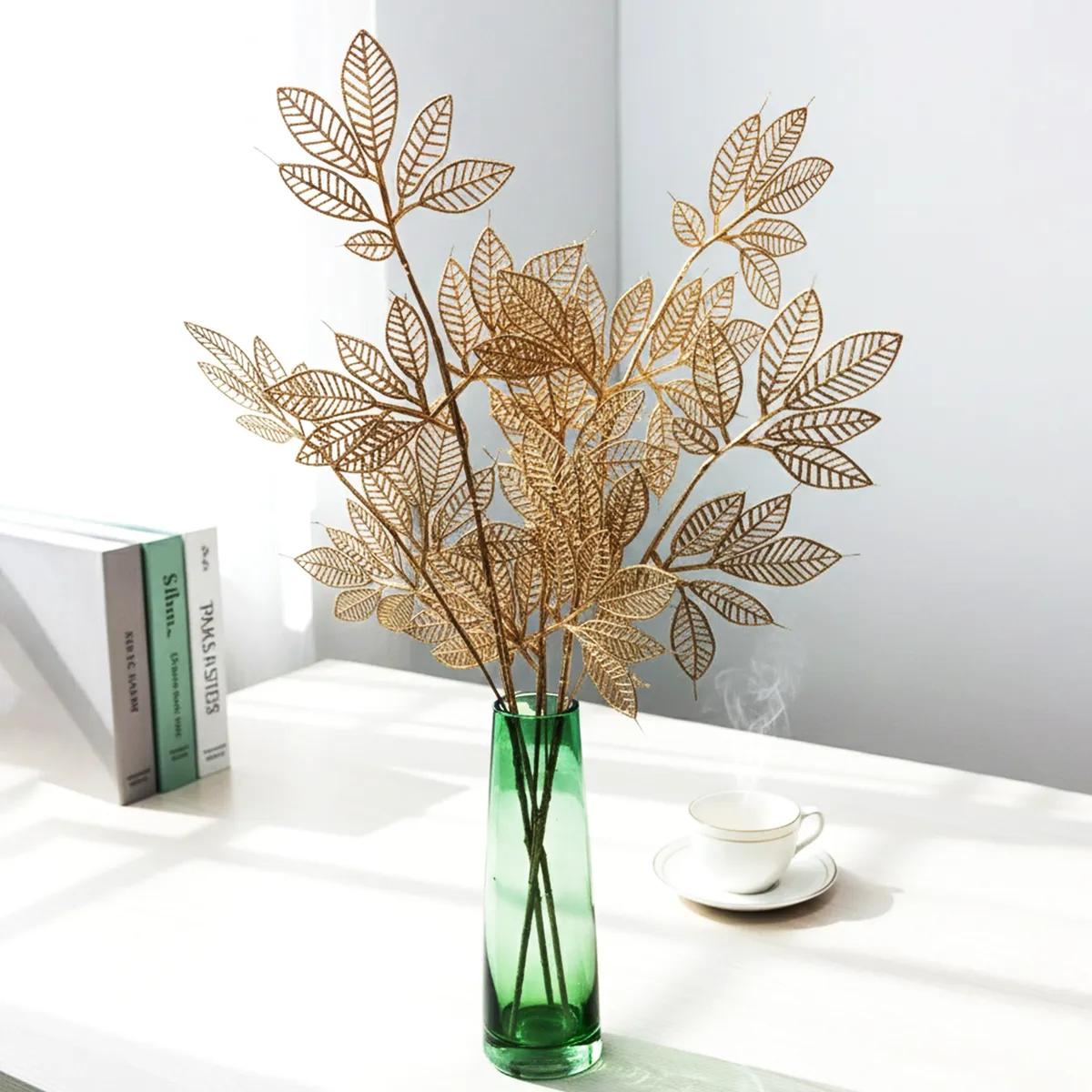 Close-up of golden artificial leaves arranged in a vase