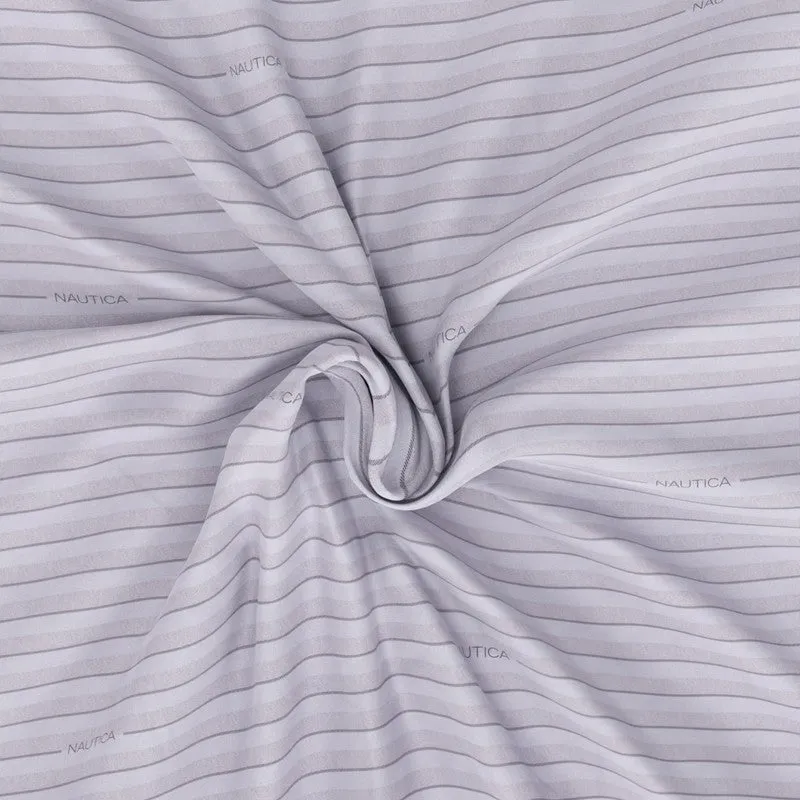 Close-up of blue striped bedsheet fabric gathered to show drape