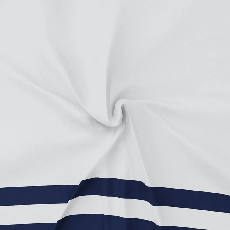 White fabric close-up showing navy stripe border and subtle surface texture