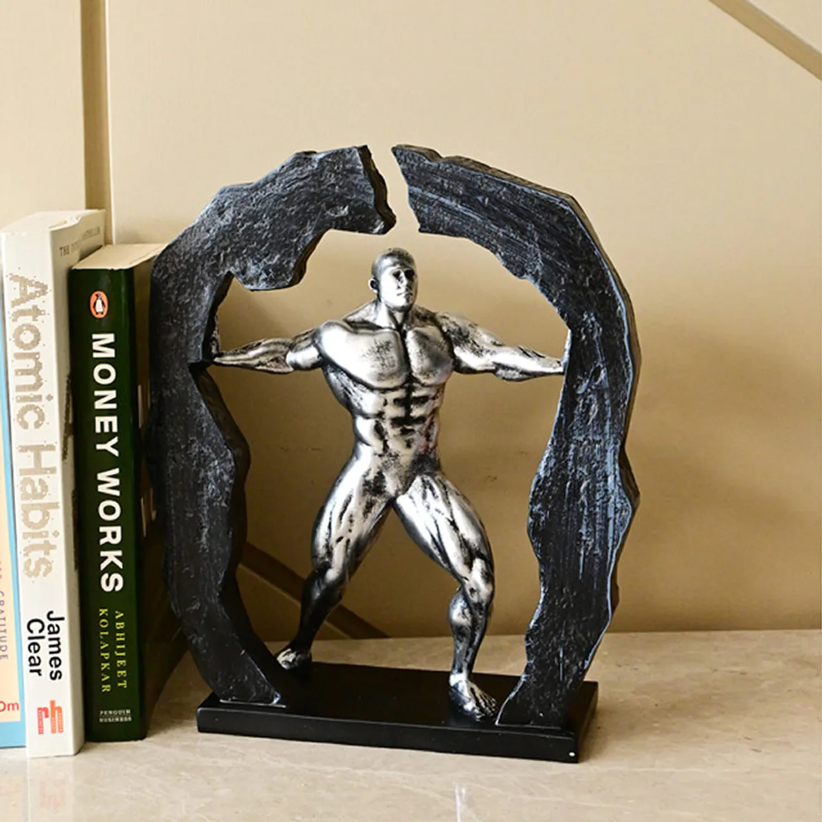 Silver figurine showpiece styled on a shelf beside books