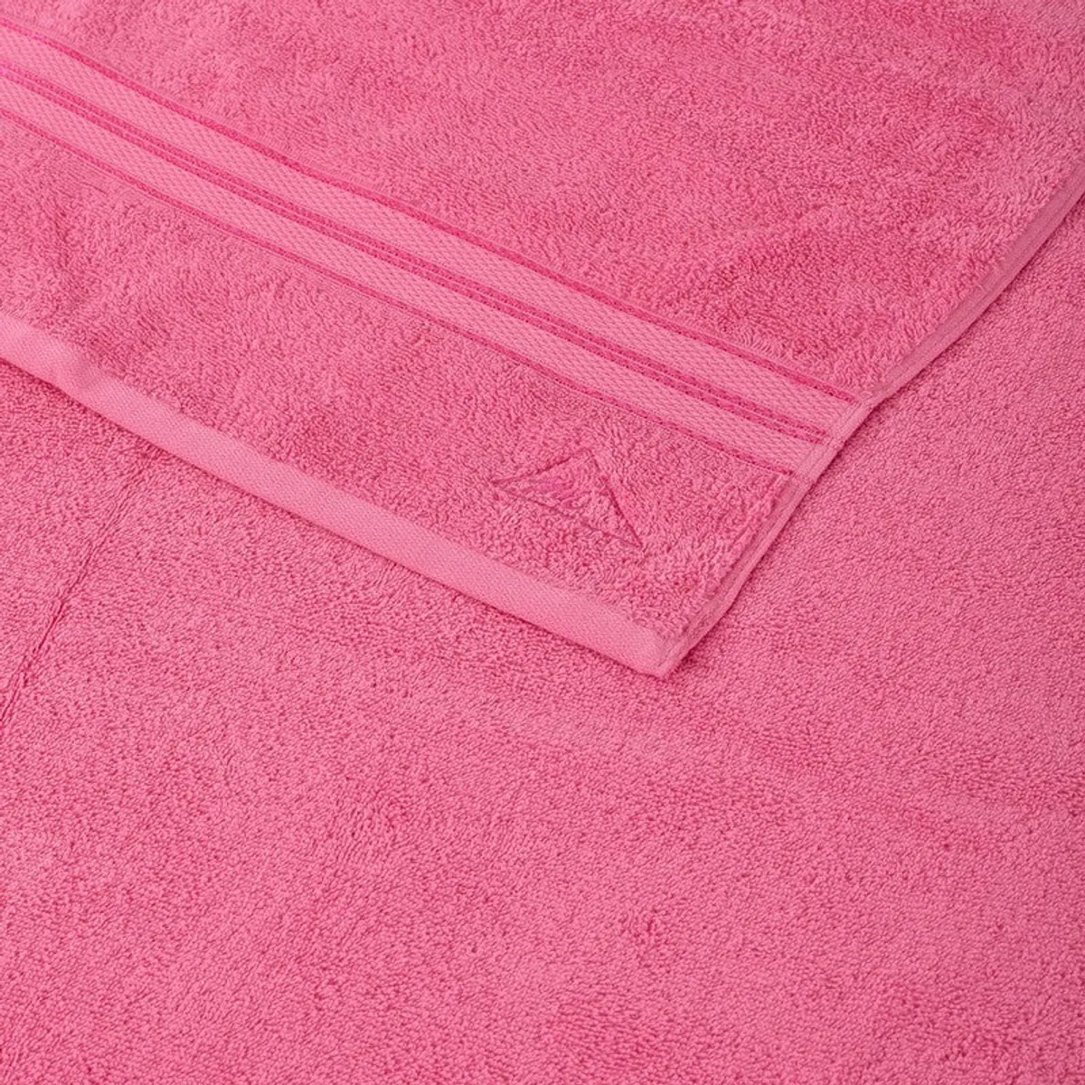 Close-up of the pink towel showing its solid texture and finished border