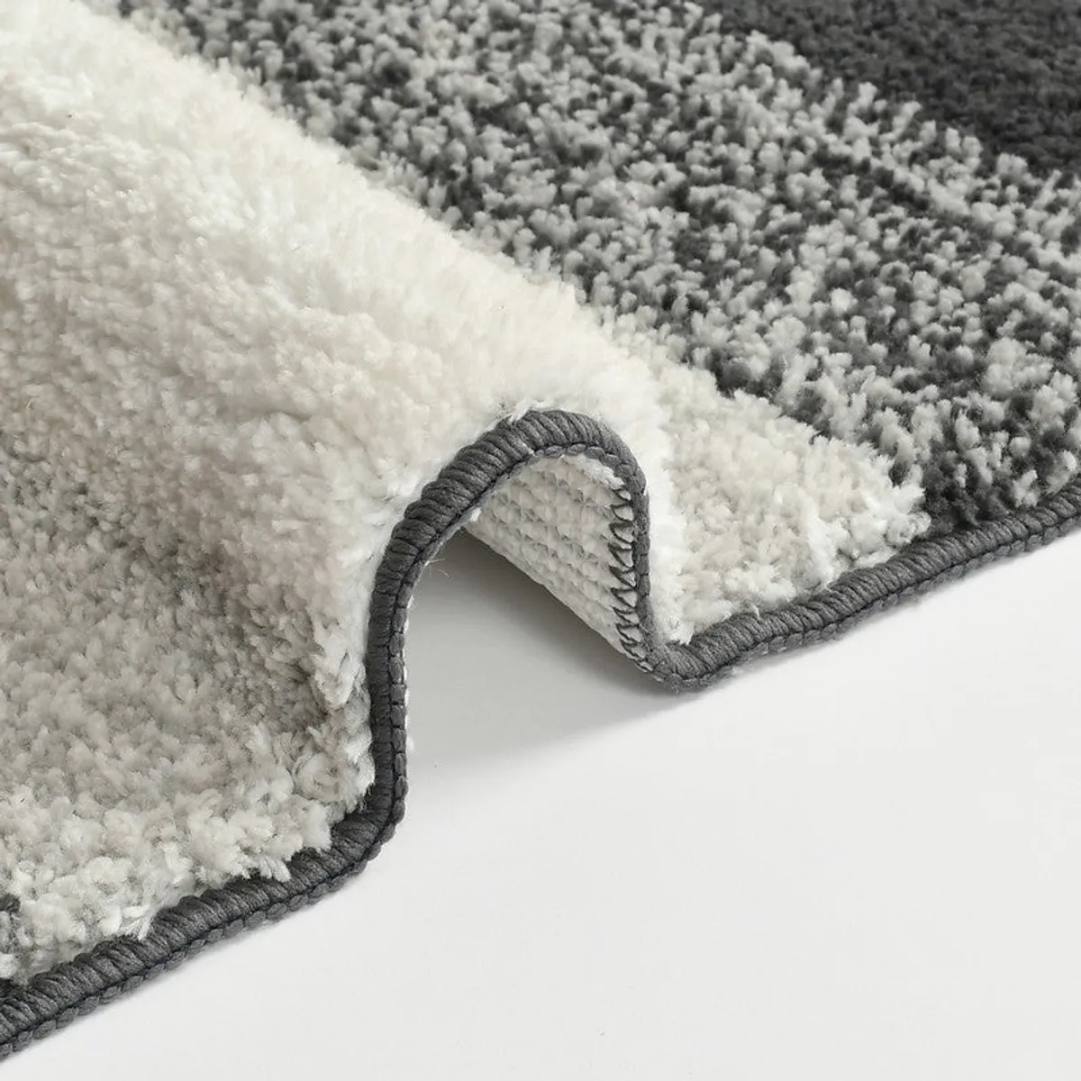 Close-up of the bath mat's plush textured surface and rubber backing