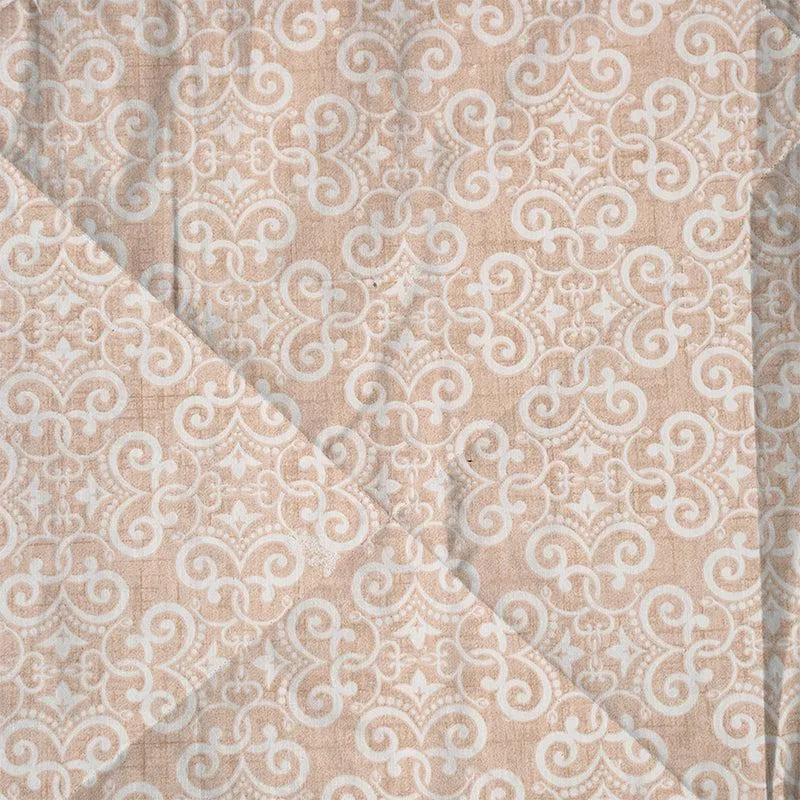 Close-up of brown and white bedding with stitched comforter surface