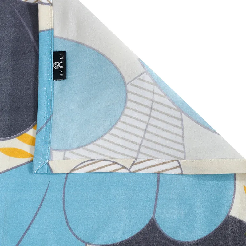 Folded corner detail of the blue printed bedsheet