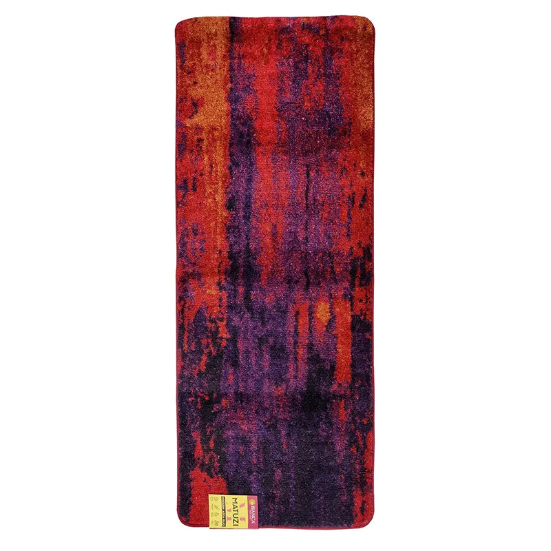 Full view of a purple and orange abstract runner rug on a white background