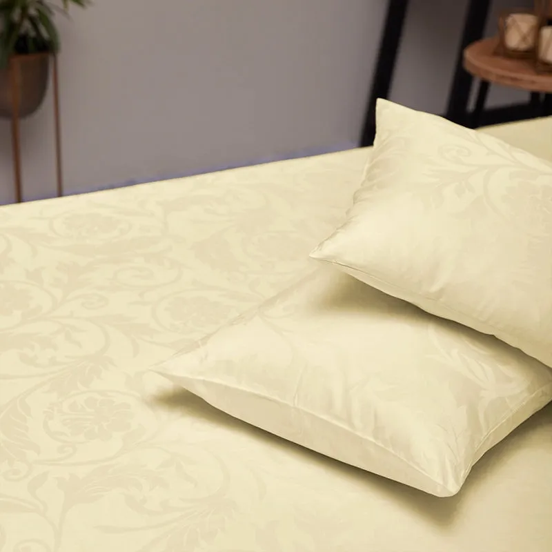 Ivory patterned duvet cover and pillow arranged on a bed