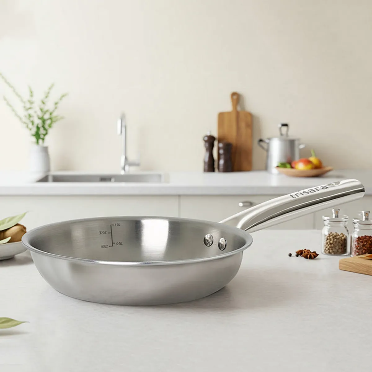 Empty silver frying pan displayed on a light kitchen countertop
