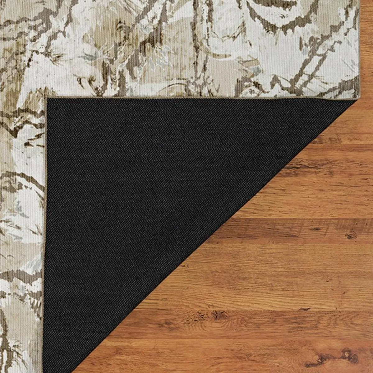 Underside corner showing the black backing of the abstract carpet