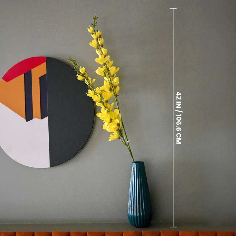 Yellow artificial flower stick shown with a height guide beside a tall teal vase.