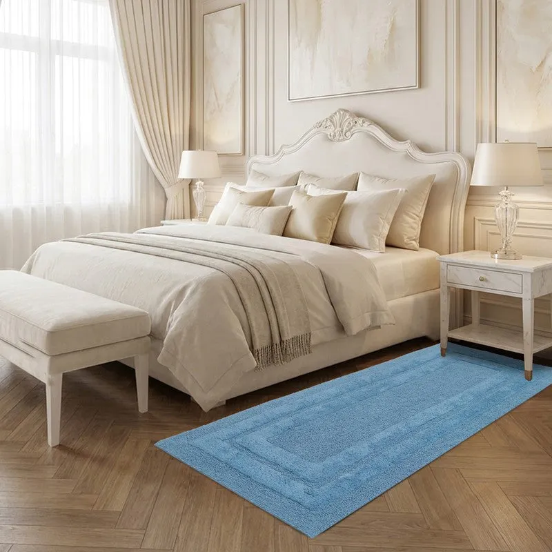 Light blue runner rug styled beside a bed in a classic bedroom
