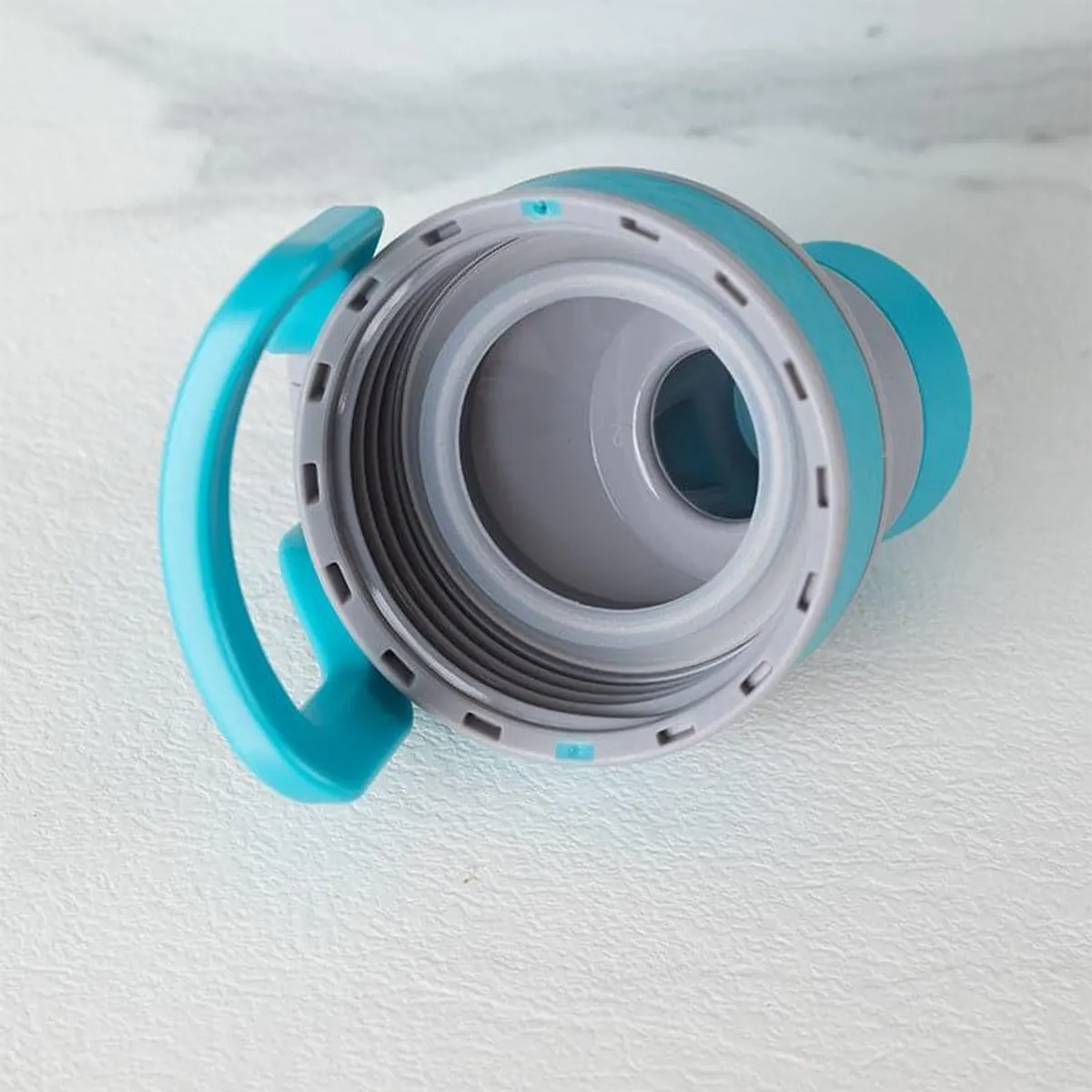 Blue insulated bottle shown from above with its open grey-and-blue lid