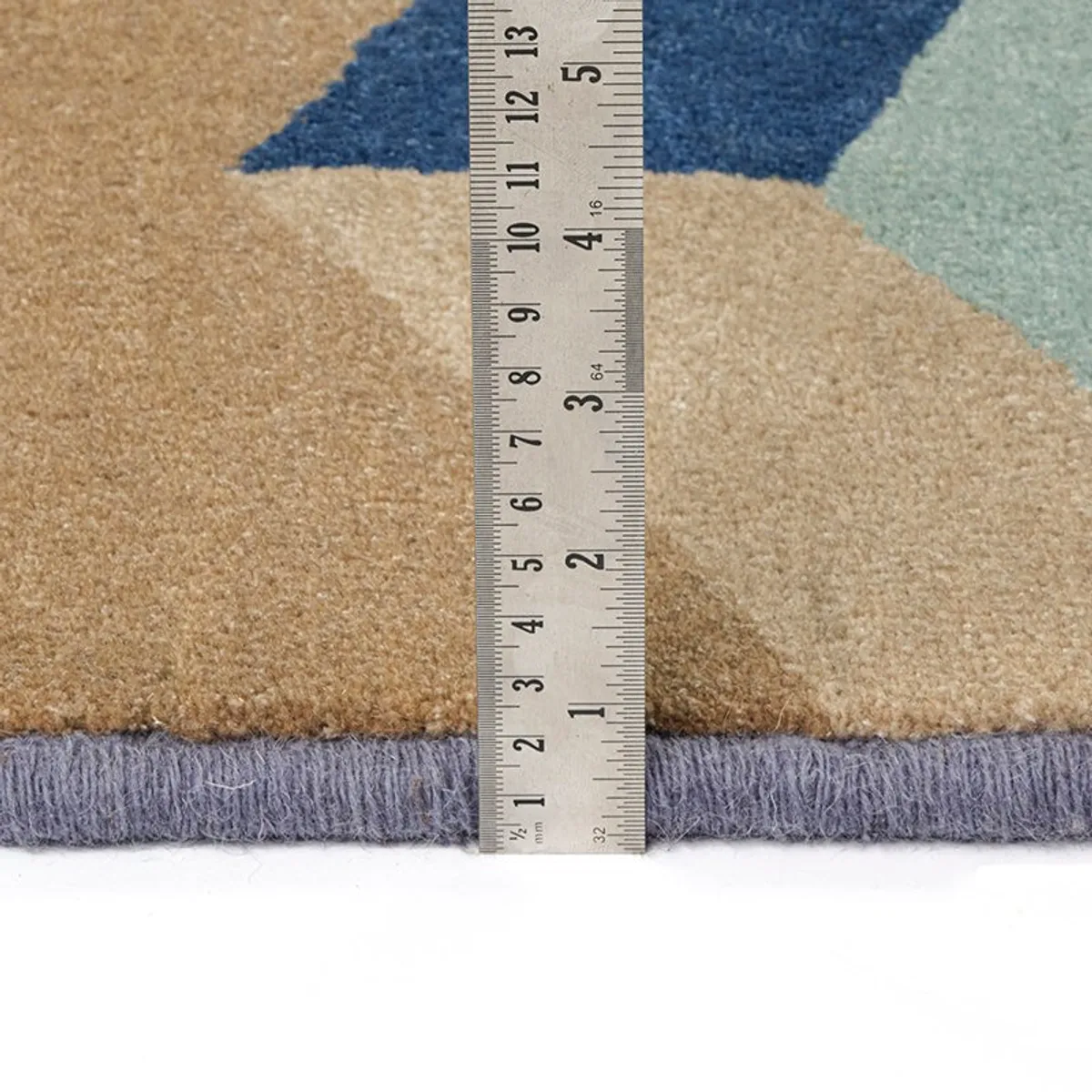 Close-up of carpet edge and pile thickness beside a ruler